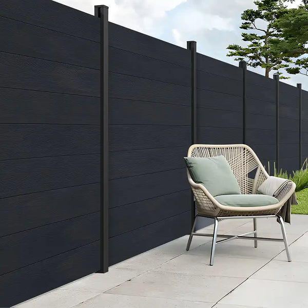 Charcoal composite fencing installed in an outdoor garden space