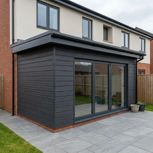 Dark charcoal composite cladding panels for low-maintenance exterior walls
