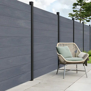 Grey composite fence panels installed in outdoor garden space